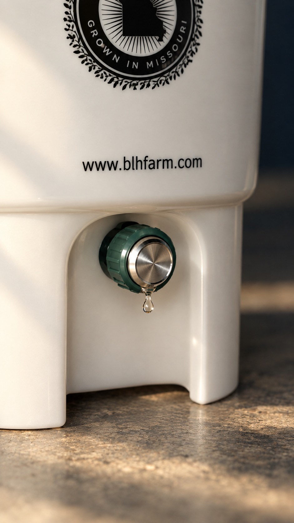 Close-up of the BLH Farm bokashi bin drain tap with a drop of compost tea