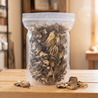 Clear bag of dried oyster mushrooms with a few mushrooms on the counter