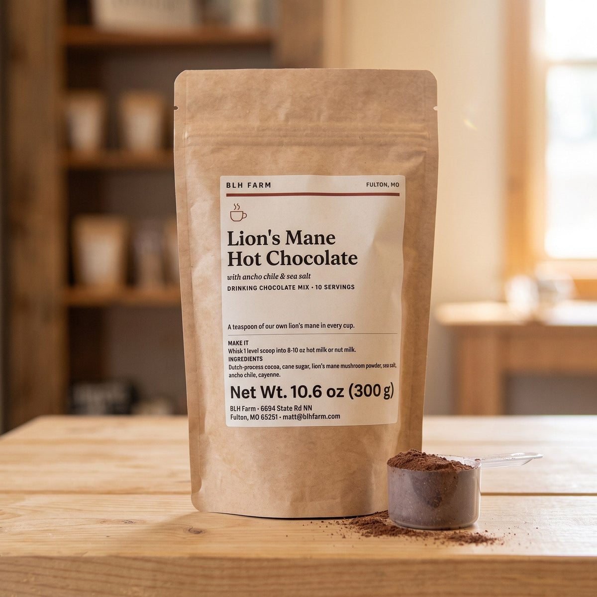 Lion's Mane Hot Chocolate 10.6 oz pouch with a scoop of cocoa mix