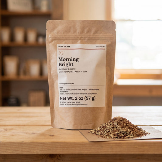 Morning Bright lion's mane and rooibos tea pouch with loose tea on a wood counter