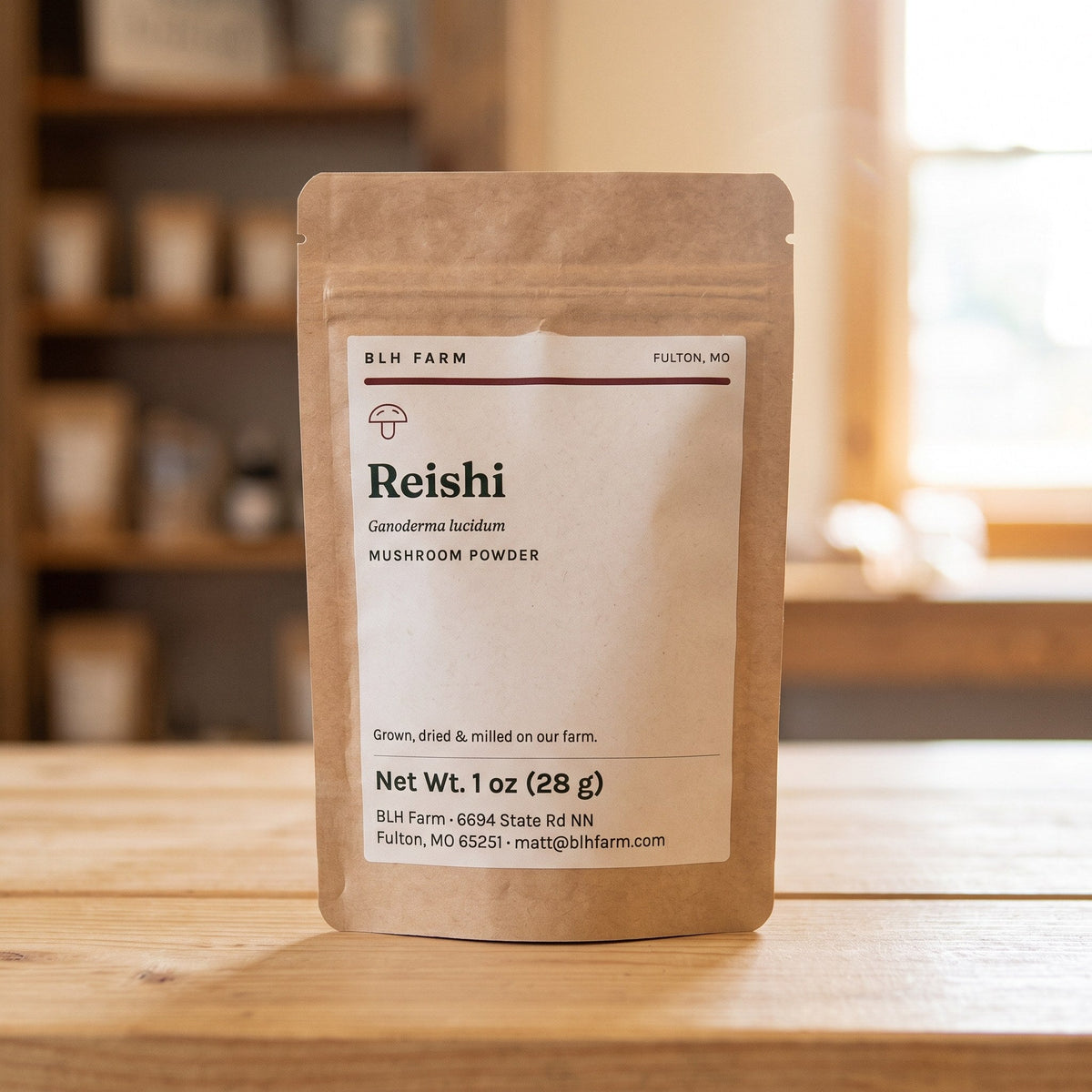 Reishi mushroom powder 1 oz kraft pouch on a wood counter